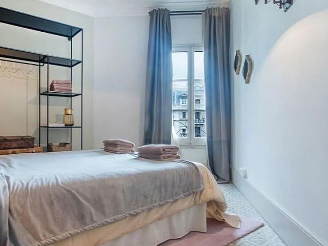 Dormitorio con cama individual, estantería azul y acceso a balcón