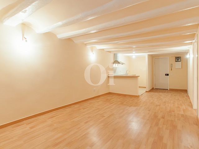 View of living room with parquet floors in renovated apartment for sale in raval