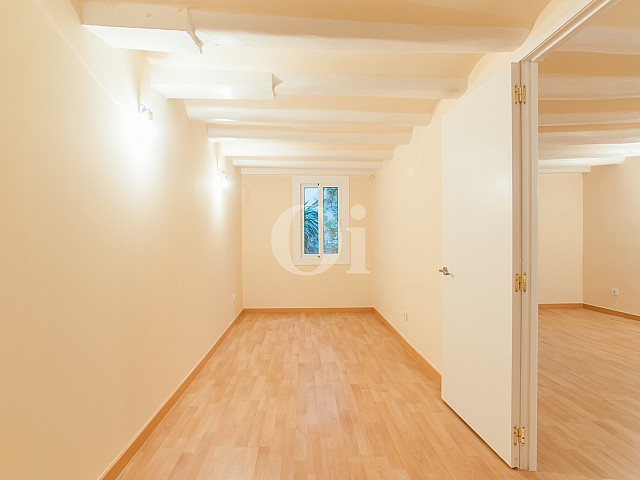 View of room with wooden beams in renovated flat for sale in Raval
