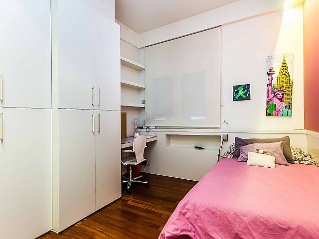 Bright and comfortable simple bedroom in luxurious apartment for sale in Barcelona